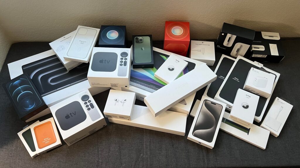 Assortment of boxed smartphones, tablets, laptops, and accessories, representing seller-refurbished, returned, or open-box inventory.